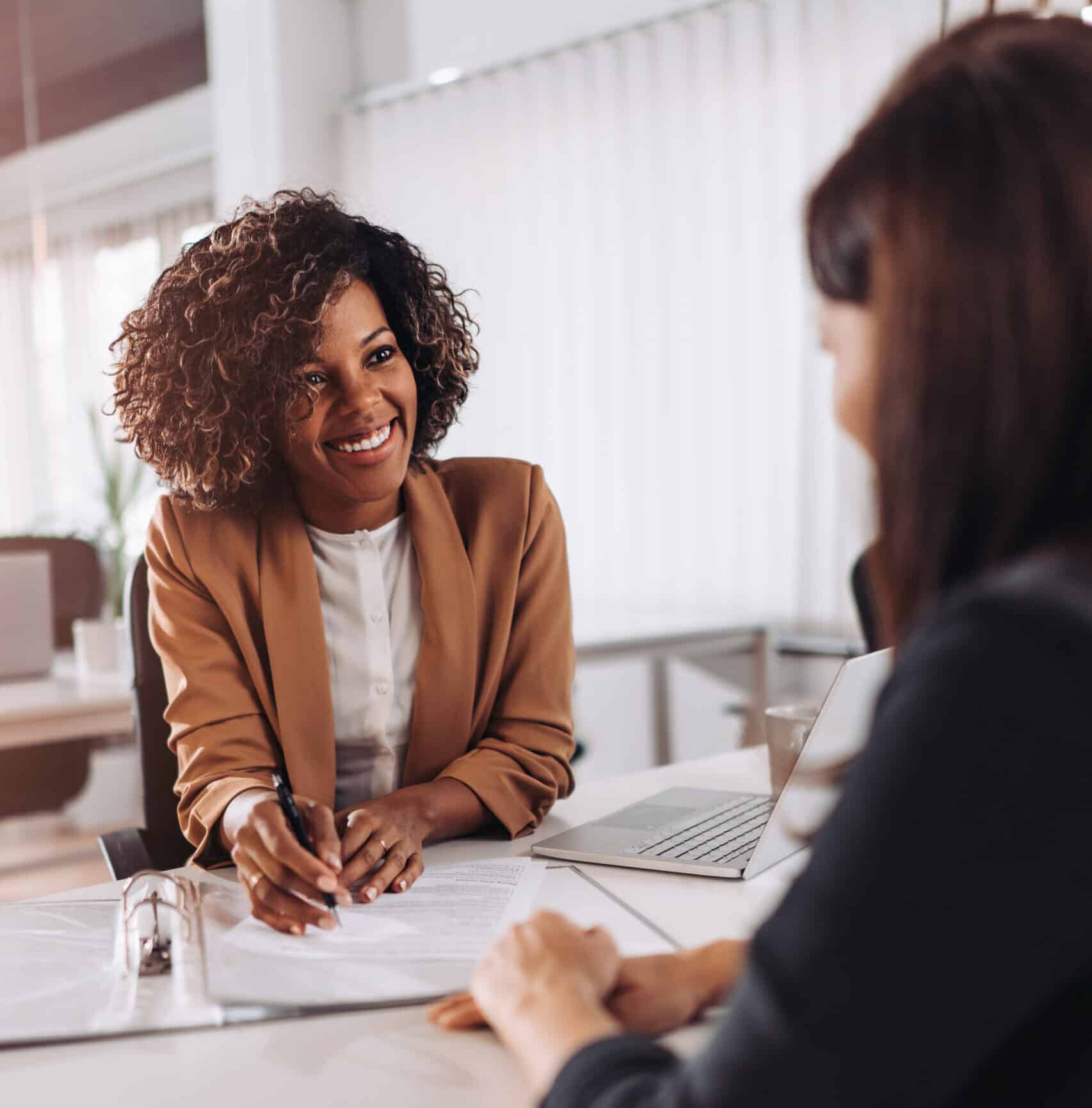 two women helping each other out in business business consulting